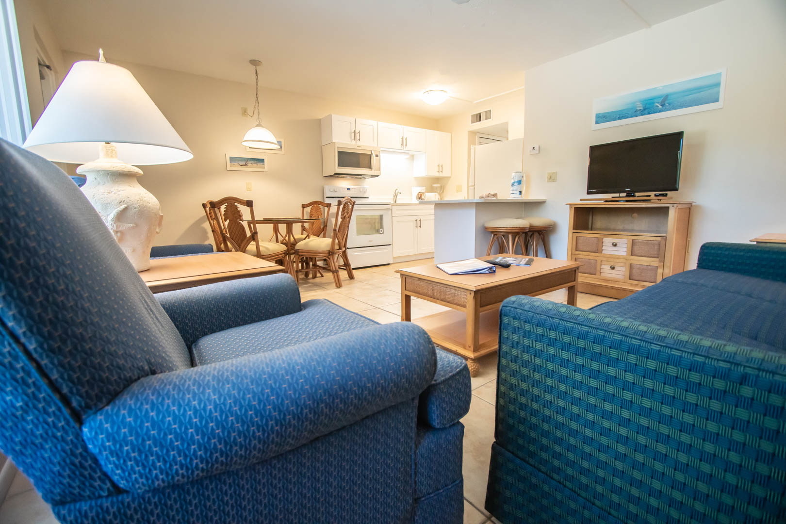A spacious living room and kitchen view at VRI's Windward Passage Resort in Fort Myers Beach, Florida.